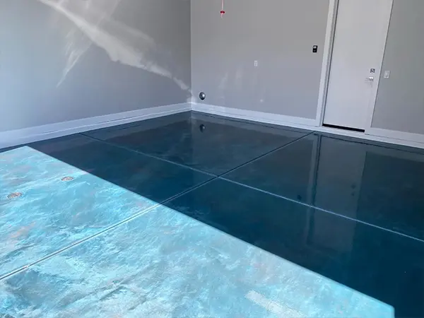 A blue epoxy floor installed by Orange Door