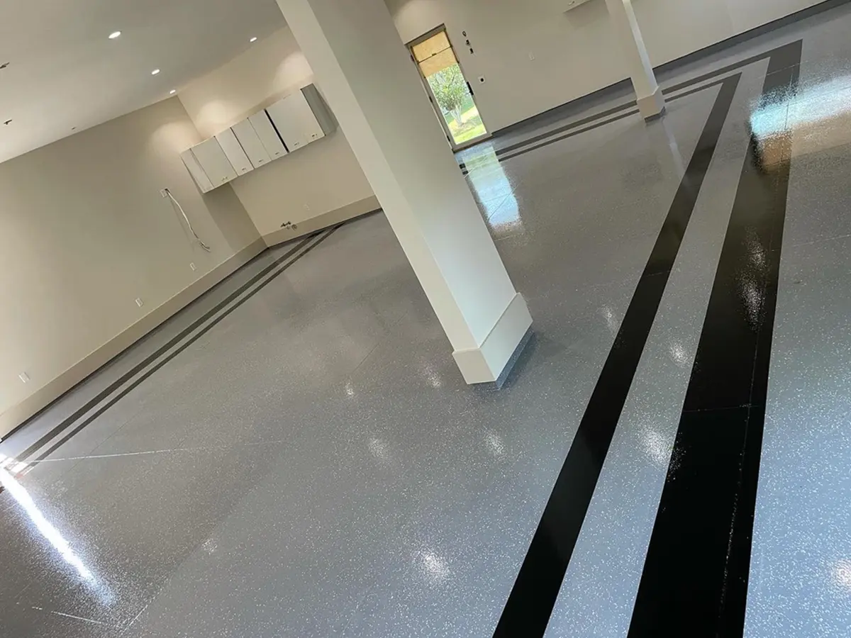 Large garage with epoxy flooring in two colors and stripes