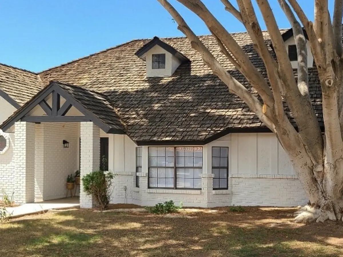 Painted white exterior of a former brick home