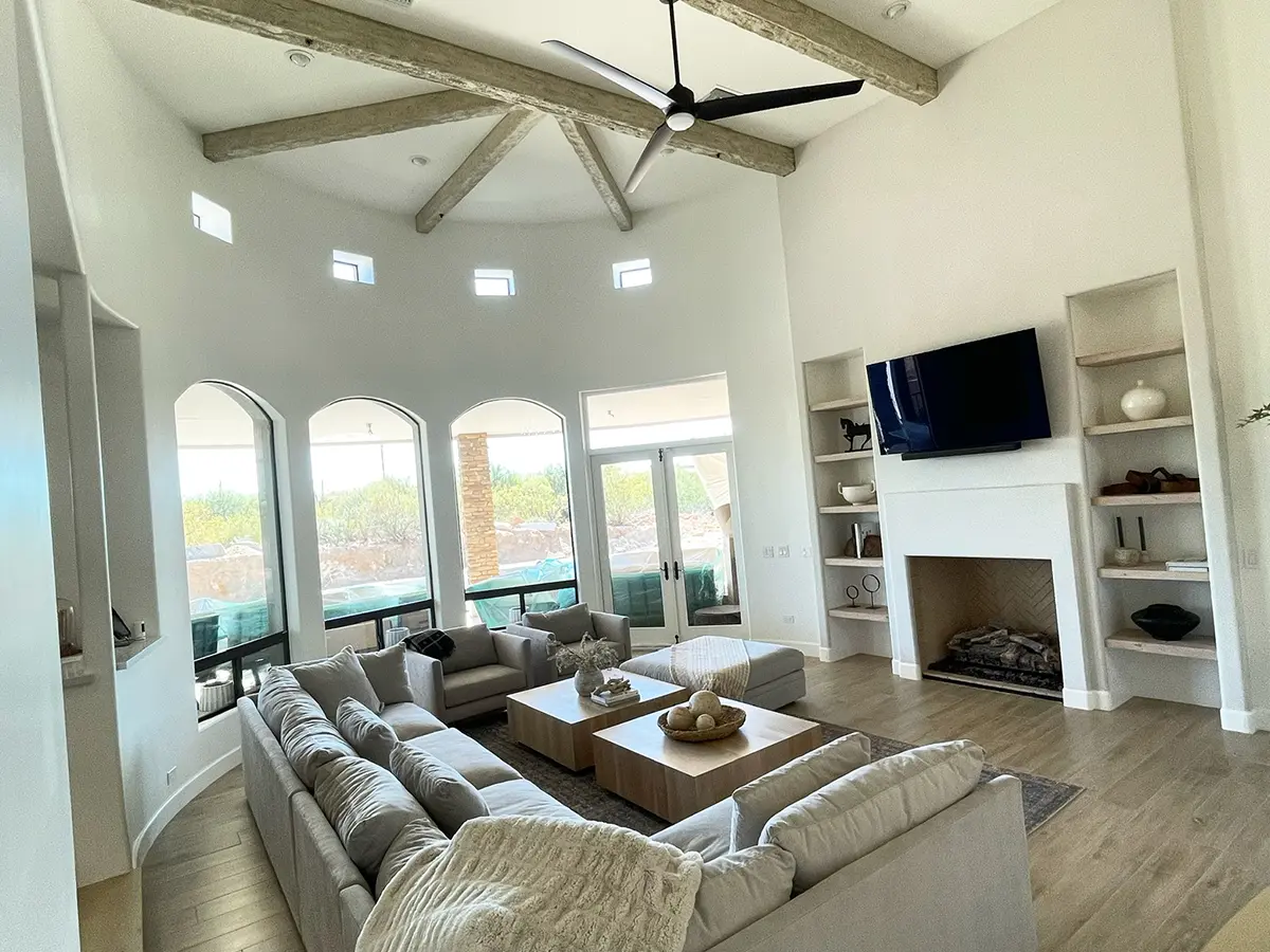 Modern white walls cathedral style living room with exposed beams and interior painting from Orange Door