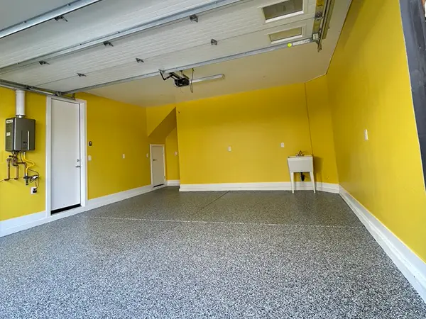 A yellow garage with polyaspartic floor in a garage