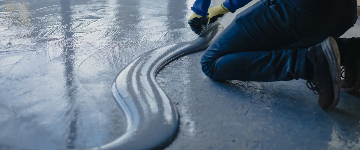 A contractor installing an epoxy floor coating