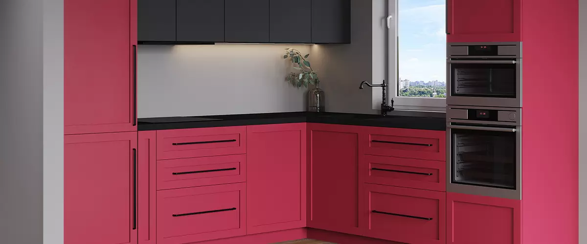 Horizontal view of the kitchen. Contrast luxury kitchen made of black graphite mdf and viva magenta 2023. No decor, black appliances, expensive and beautiful work surface. Trendy room