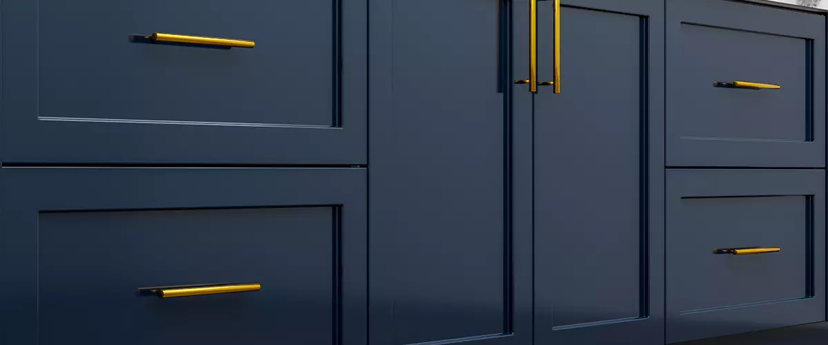 Navy blue kitchen cabinet doors and golden metal kitchen handles